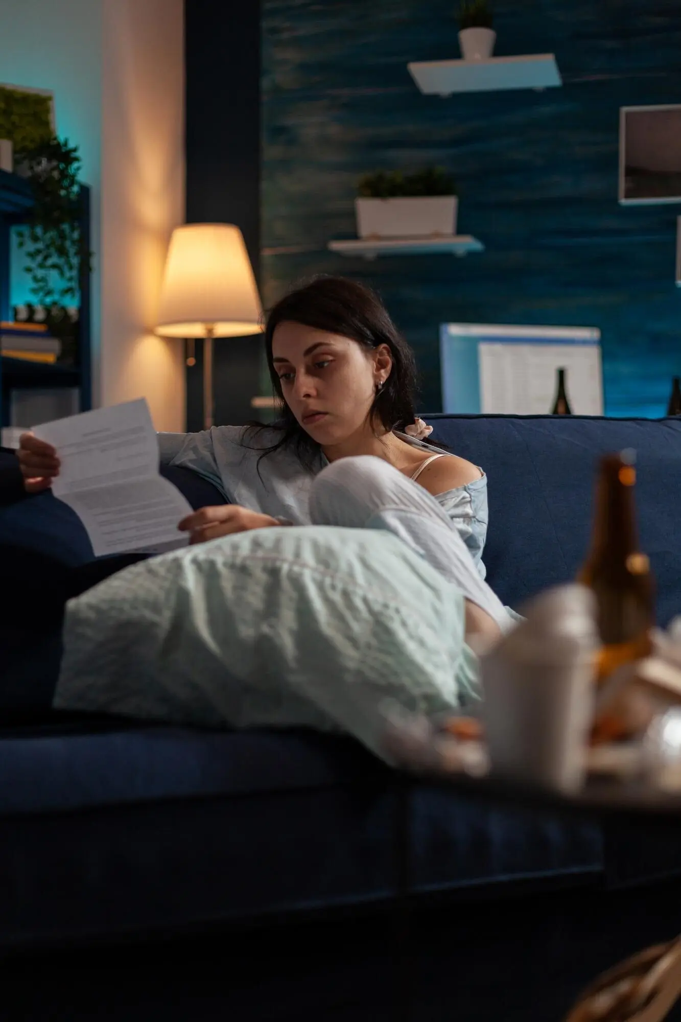 Depressed, worried woman reading an eviction notice and struggling with mental health difficulties; living with chronic depression, she has to pay the mortgage and bank debt taxes and feels desperate.