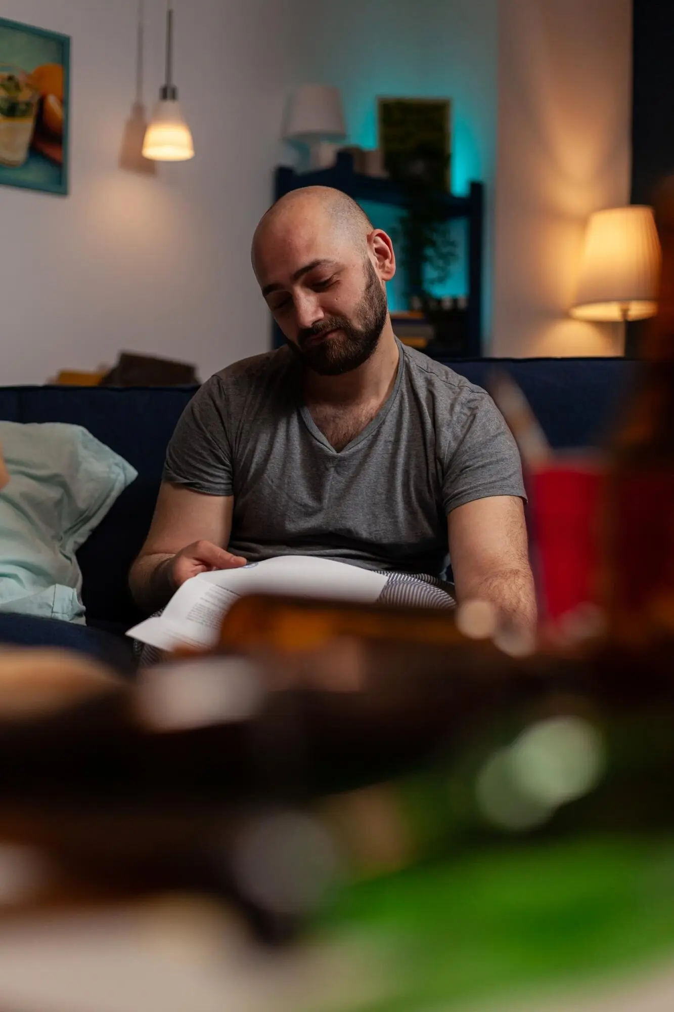 A worried, depressed man reads an eviction notice, facing financial difficulties and feeling desperate about paying taxes; sad and disappointed, he is anxious and needs to pay the mortgage.