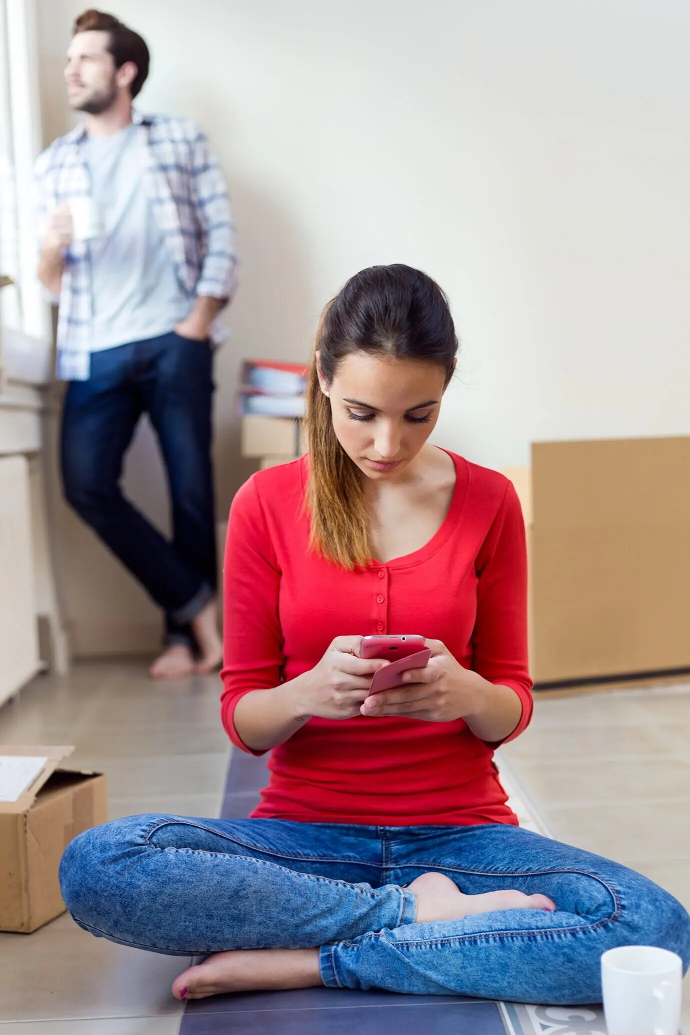 A young couple, angry, in their new home.